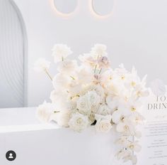 a bouquet of white flowers sitting on top of a table