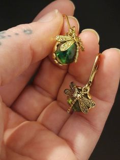 Check out this item in my Etsy shop https://www.etsy.com/listing/1059874489/dragonfly-sun-catcher-earrings Metal Earrings For May Birthstone Gift, Adjustable Gold Dragonfly Jewelry, May Birthstone Metal Earrings For Gifts, Green Hypoallergenic Jewelry Gift, Hypoallergenic Green Jewelry Gift, Green Metal Earrings For Gift, Handmade Gold Dragonfly Jewelry, Green Spiritual Earrings For Gift, Spiritual Green Earrings For Gift