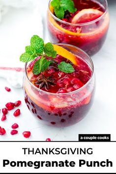 two glasses filled with pomegranate and garnished with mint on top