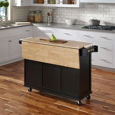 a kitchen island sitting on top of a hard wood floor