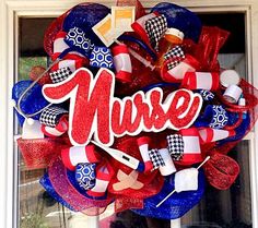 a red, white and blue mesh wreath with the word nurse on it in front of a window