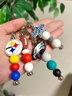 a hand holding a bunch of different colored beads