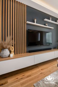 a modern living room with wood paneling on the wall and entertainment center in the middle