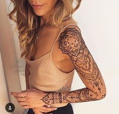 a woman with tattoos on her arms and arm