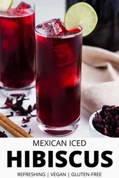 two glasses filled with mexican iced hibiscus and garnished with limes