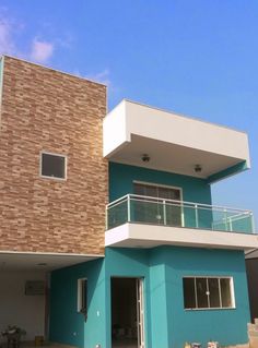 a blue and white building with a balcony