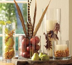 a table topped with vases filled with different types of fruits and veggies