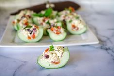 cucumbers stuffed with crab salad on a white plate