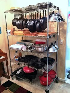 a kitchen shelving with pots and pans on it