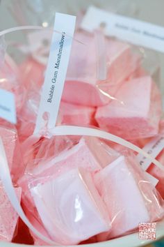 pink marshmallows in a bowl with labels on them