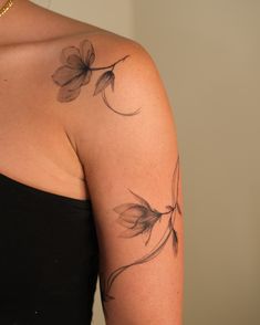 a woman's arm with flowers on it