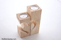 two wooden candles sitting on top of each other