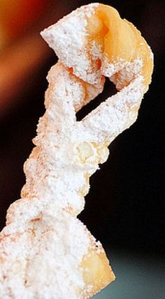 a powdered sugar covered donut with a spiral design on it's side