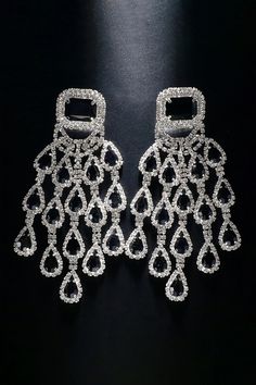 Elevate your style with our Diamond Floral Fringe Earrings. These stunning earrings showcase intricate diamond-encrusted floral designs with delicate fringe details. The combination of diamonds and cascading fringes adds a touch of sophistication and movement, making them a perfect accessory for special occasions. Embrace a look that effortlessly blends luxury and trendiness with these captivating earrings. Glamorous Tassel Earrings For Wedding, Diamond White Dangle Earrings For Party, Diamond White Drop Diamond Earrings For Party, Party Diamond White Drop Diamond Earrings, Diamond White Crystal Chandelier Earrings, Diamond Dangle Chandelier Earrings For Party, Diamond White Crystal Chandelier Dangle Earrings, Diamond Chandelier Dangle Earrings For Party, Crystal Chandelier Earrings With Rhinestone Fringe