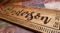 a wooden sign that says jackson on it with pegs attached to the front and sides