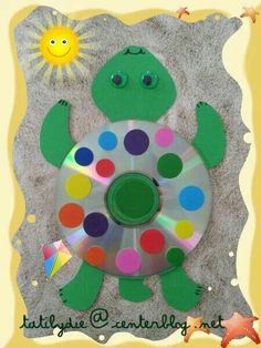 an image of a turtle on the beach with cd's in its hand and a sun above it