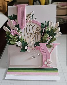 a close up of a greeting card with flowers and leaves on the inside of it