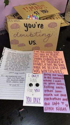 some cards are laying on top of each other with words written on them, and one card is in the shape of a box that says you'rejotting us