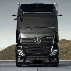 the front end of a black mercedes semi truck