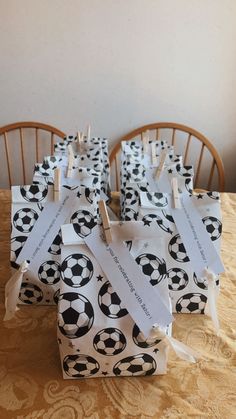 there are many small bags with soccer balls on them sitting on the dining room table