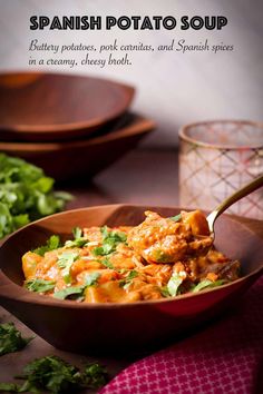 a wooden bowl filled with food and garnished with cilantro