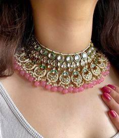 Adorn yourself in timeless elegance with this exquisite rose pink Kundan necklace set, perfect for weddings and special occasions. Crafted with meticulous attention to detail, the set features delicate pink  hues reminiscent of Pakistani and Punjabi traditions, with a touch of Bollywood glamour. Complete with matching earrings and a stunning maangtika, this Indian Kundan ensemble effortlessly captures the essence of sophistication and grace. Measurements:  Weight- 155 gms  Necklace Length-14 " W Luxury Pink Kundan Necklace For Wedding, Pink Kundan Necklace For Festivals, Pink Round Kundan Necklace For Diwali, Pink Kundan Necklace With Tilla, Pink Kundan Necklace With Tilla Detail, Pink Bollywood Kundan Necklace, Bollywood Style Bridal Necklace With Tilla In Pink, Pink Bollywood Style Kundan Necklace, Pink Bollywood Bridal Necklace With Tilla