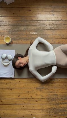 a woman laying on top of a yoga mat