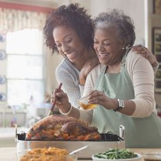 two women preparing food in the kitchen together