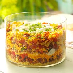 a glass bowl filled with food sitting on top of a table