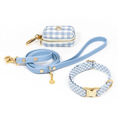 a blue and white checkered leash with gold hardwares on the end, next to a small purse