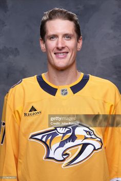 an ice hockey player poses for a portrait