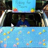 a man sitting in the back of a car with a sign on it's roof