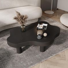 a black coffee table sitting on top of a rug