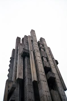 a very tall building with many windows on it's sides and a clock at the top