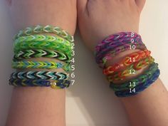 two hands holding different colored bracelets with numbers on each wrist and one has an arrow in the middle