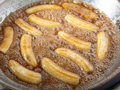 banana slices are being cooked in oil on the stove top with brown sugar around them