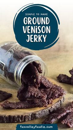 a jar filled with brownies sitting on top of a wooden table next to a pile of cookies