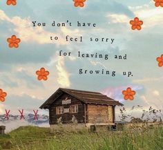 an old log cabin sitting on top of a grass covered hill with flowers in the sky