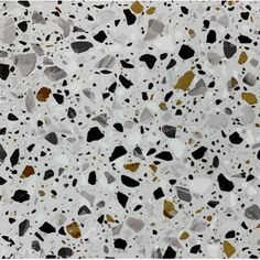 a white and black speckled surface with gold foil on the top, in different colors