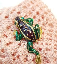 Vtg Climbing Tree Frog brooch pin. Figural, amphibian, animal. Green and purple enamel. Unsigned. Vintage new old stock. 1980-1990's era. No tag/card. From jewelry shop estate that closed in 2002. Please see all photos for measurements and visual details. Any props used in photos are not included unless stated otherwise. We will gladly combine shipping for more than 1 item when possible but must let us know before sending payment. Most of our items are preowned, used and/or vintage (unless stated new) with typical wear and we have no way of knowing previous environment exposures. We use recycled packing supplies as much as possible. Please check out our eBay store and thank you visiting. Frog Brooch, Packing Supplies, Tree Frog, Frog And Toad, Tree Frogs, Enamel Jewelry, Amphibians, Toad, Vintage Watches