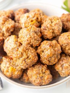 a white bowl filled with meatballs on top of a table