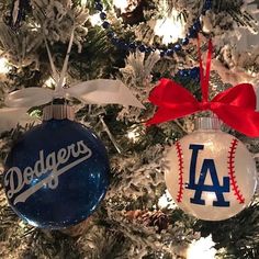 two dodgers ornaments hanging from a christmas tree