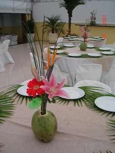 an image of a table setting with plates and flowers in the vase on the table