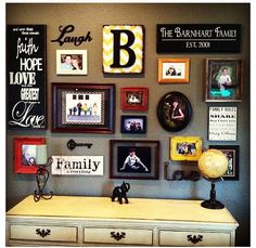 a white dresser topped with lots of framed pictures