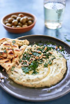 hummus, pita bread and olives on a plate