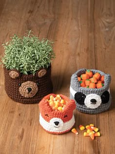 three crocheted baskets with carrots and vegetables in them on a wooden surface