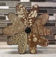 a flower made out of wood sitting on top of a white counter next to tile