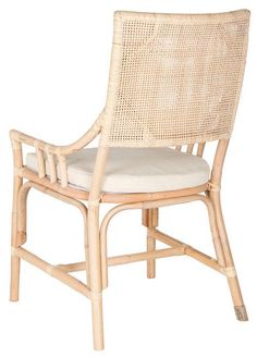 a wicker chair with a cushion on it