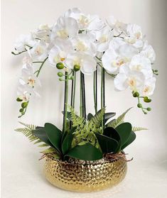 This orchid arrangement is planted in a stunning Gold ceramic planter. The modern vase makes it look great anywhere in your home! Product detail: Material: PEVA Real Touch Size: 21.6 Inches Tall Color: Green Gold Ceramic pot Handmade Care: The flower can be washed with water. Imported Orchid Vase, Orchid Flower Arrangements, Diy Outdoor Fireplace, Gold Orchid, Artificial Orchids, Orchid Arrangements, Arrangement Ideas, Phalaenopsis Orchid, Vase Arrangements