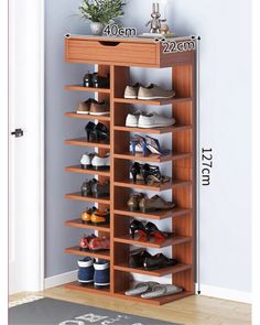 the shoe rack is made from wood and holds many pairs of shoes